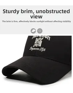 Close-up of black baseball cap with white Improve Life embroidery and reinforced brim