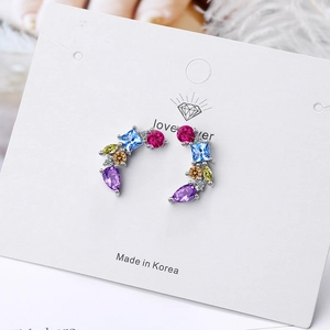 Fashionable arc stud earrings featuring colorful cubic zirconia set in silver metal