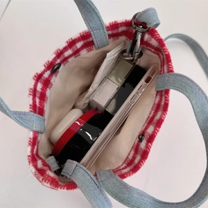 Top view of plaid wool tote bag showing blue denim handles and interior storage capacity
