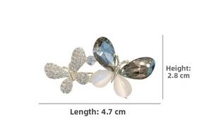 Detailed close-up of double butterfly brooch with blue crystals and size 4.7cm x 2.8cm