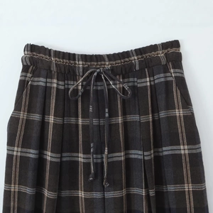 Brown plaid pants with elastic waistband and drawstring detail for a casual look
