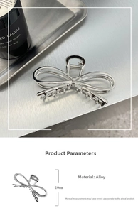 Macro detail of a 10cm polished silver alloy bow hair claw with product dimensions