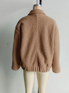 Rear view of brown wool blend jacket featuring a textured finish and elasticated hemline
