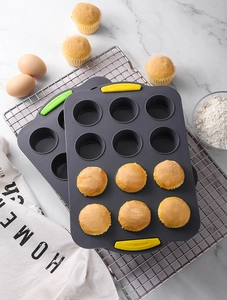 Detailed view of 12-cup silicone muffin pans on a metal rack with baking ingredients