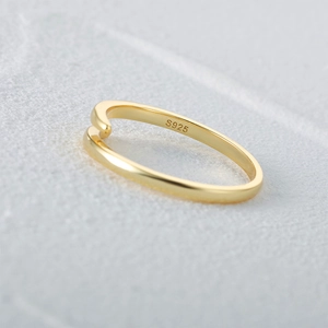 Macro shot of S925 sterling silver hallmark inside the golden cross open ring