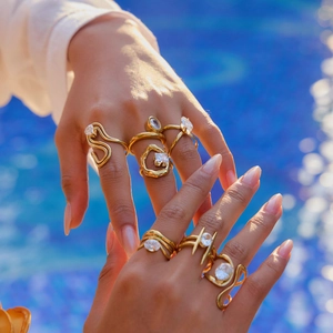 Close-up of titanium steel gold rings with cubic zirconia stones worn on model hand