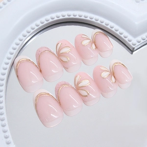 French style floral press-on nails with gold edges and pink gradient on a round mirror