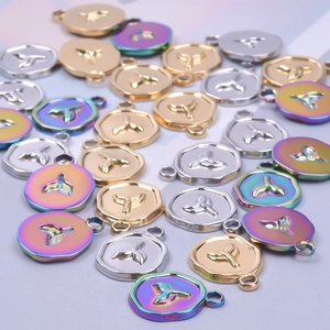 Minimalist stainless steel whale tail pendants in gold silver and rainbow finishes