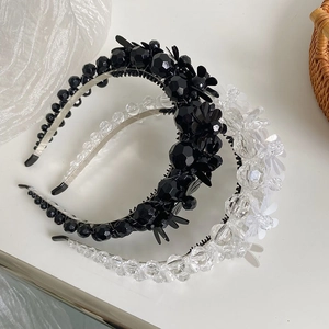 Detail view of three beaded headbands featuring floral sequins and elegant crystal pearls