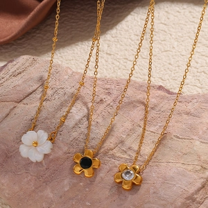 Three elegant gold daisy necklaces with white shell black agate and zircon floral pendants