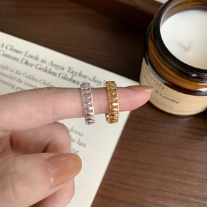 Hollow leaf pattern rings in gold and silver finish shown on fingers with magazine