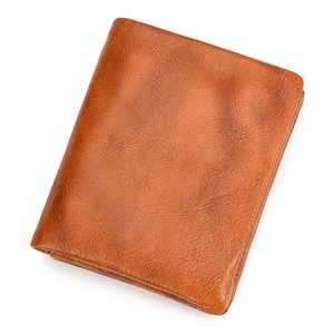 Detailed macro view of a brown genuine leather wallet with natural grain texture