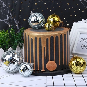 Macro detail of silver and gold mirror disco balls for cake decoration and parties