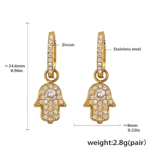 Detailed view of gold stainless steel Hamsa Hand earrings with micro zircon inlays