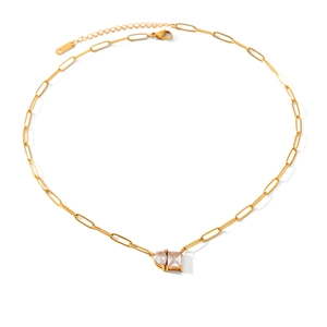 Detail view of gold paperclip chain necklace with pear and emerald cut zircons