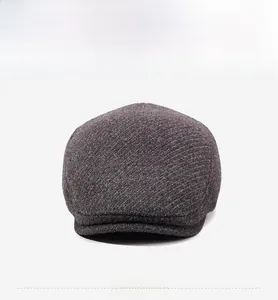 Detailed close-up of textured wool blend fabric on a grey winter flat cap for men