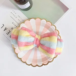 Colorful striped plush bow headband in soft coral fleece for face washing and makeup