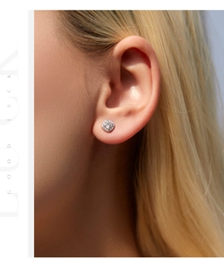 Macro close-up of a s925 silver halo stud earring with D-color moissanite on a model ear