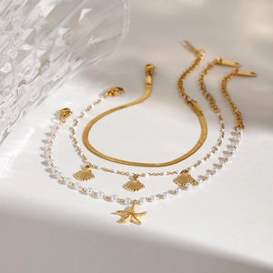 Gold stainless steel bracelet set with pearls, seashell and starfish charms for beach vacation
