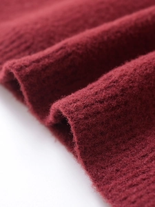 Macro detail of wine red ribbed knit fabric with soft fuzzy texture for spring sweater