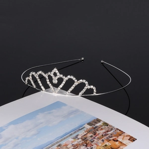 Silver bridal crown headpiece with sparkling rhinestone heart design on a white card