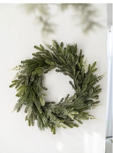 Close-up of artificial green PE Christmas wreath with pine needles and fern leaves