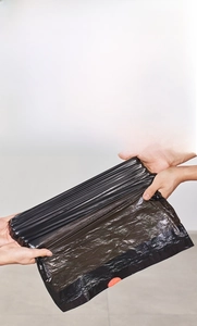 Detail showing high-toughness thick black drawstring trash bag with puncture resistance