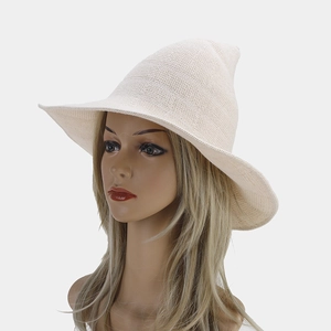 Macro view of cream knit witch hat texture with pointed crown and wavy wide brim detail