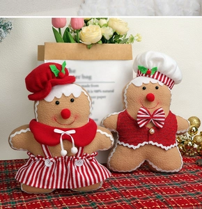 Detail of Christmas gingerbread plush dolls with festive red and white striped clothes