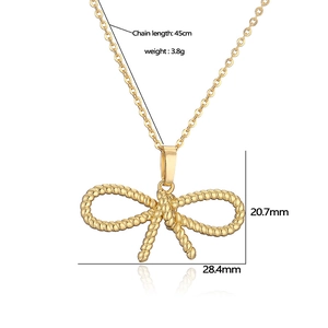 Detail of gold bow necklace pendant with rope texture and size specs 28.4mm x 20.7mm