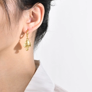 Polished 18k gold mushroom-shaped stainless steel hoop earrings on female model