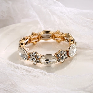 Detailed shot of elastic alloy bracelet with white crystal stones on lace background