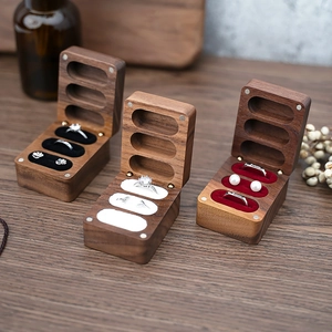 Detailed comparison of walnut wood rings boxes with black, white, and red velvet inserts