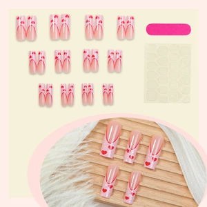 Long French press-on nails set with red hearts, including nail file and adhesive tabs