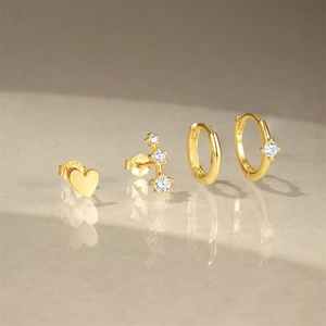 Macro shot of a four-piece gold-plated S925 silver earring set with zirconia accents