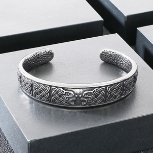 Detail of Viking wolf head bangles with Celtic knot patterns and a vintage steel finish