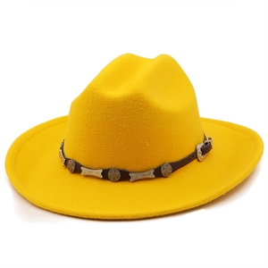 Detail of yellow wool cowboy hat with leather band and star metal ornaments