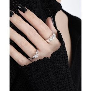 Irregular textured S925 sterling silver ring with shimmering crystals on a hand