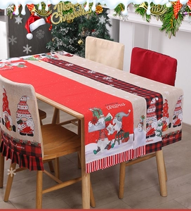 Detail of Christmas table runner and chair covers with gnome print on a wooden dining table