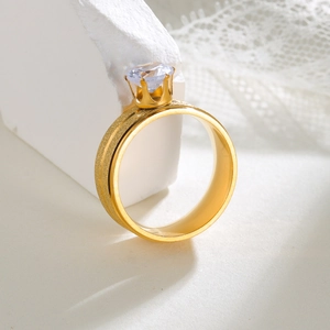 Detailed close-up of 8mm gold-plated stainless steel ring with crown-set cubic zirconia stone