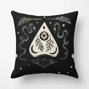 Detail of Halloween black cushion cover with white occult mystical eye and snake patterns