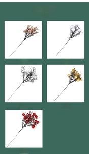 Close-up of artificial Christmas berry stems in gold, silver, red, white, and champagne
