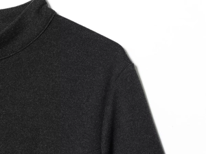 Detail view of charcoal grey high-neck knit fabric with high-quality stitching texture