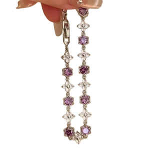 Elegant silver bracelet with hexagonal purple zircons and floral crystal charms
