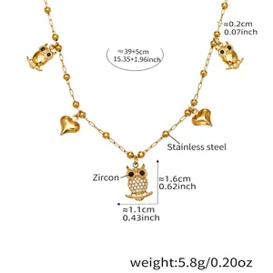 Detailed view of golden owl and heart pendants on stainless steel zircon necklace