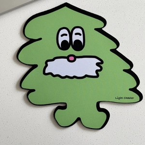 Detailed macro view of green cartoon Christmas tree mouse pad with Light Chaser logo