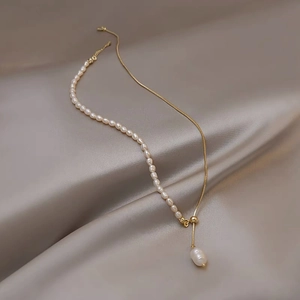 Elegant adjustable freshwater pearl necklace with gold chain and teardrop pendant on silk