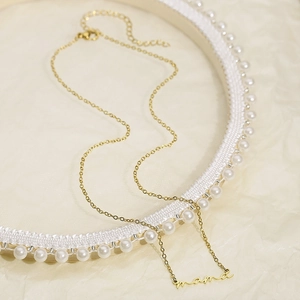 Detailed macro shot of golden Mama script necklace with adjustable extension chain