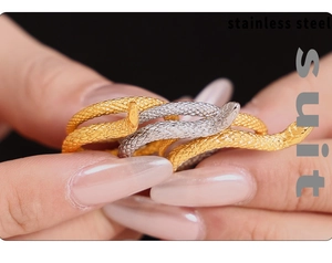 Close-up of double layered gold and silver snake rings with detailed scale textures