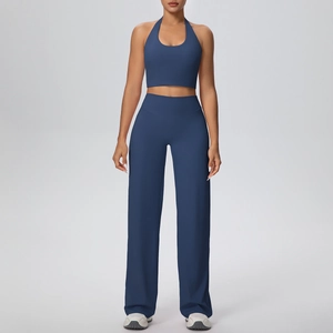 Detail of high-stretch matte fabric on dark blue halter crop top and yoga pants